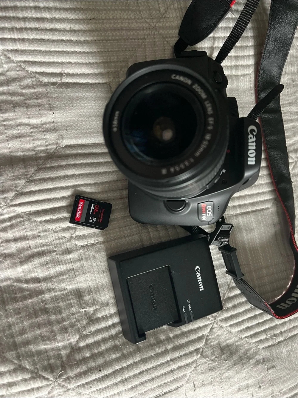 Canon Black DSLR with 18-55mm Lens and Red-Trim Strap